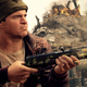 A solider from Call of Duty aims his gun off screen.